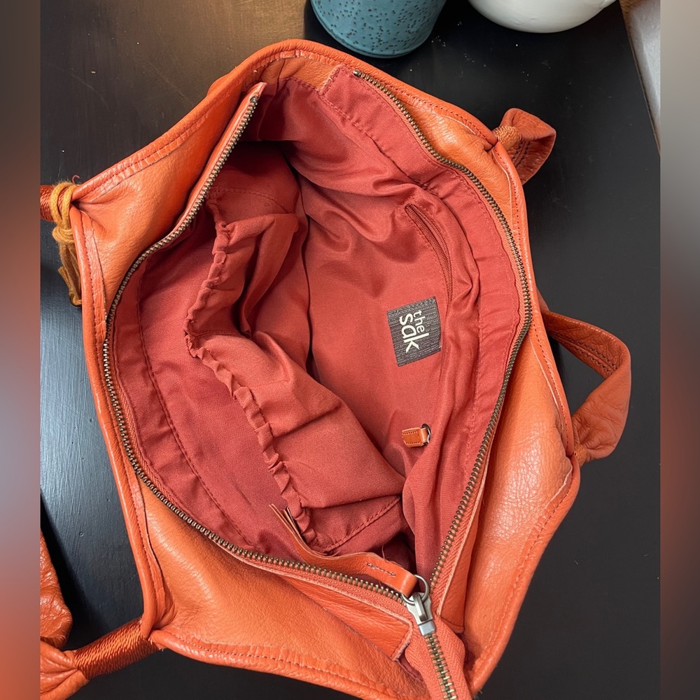 The Sak Leather Orange Bucket Bag with two wide straps.  Two interior pockets. - Picture 3 of 3